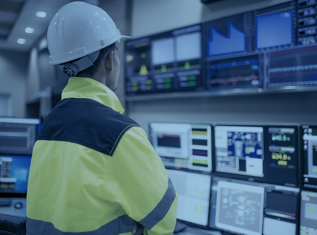 An energy management employee of UPM Mechanical looks over a series of monitors to ensure the project is running smoothly