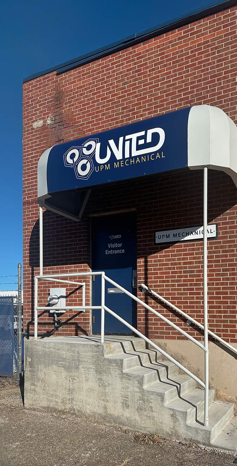The exterior view of the visitor entrance of the United UPM Mechanical building in Denver, Colorado