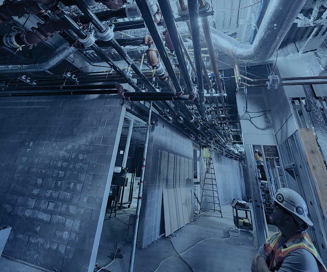 A service technician looks over a Mechanical Piping installation job of UPM Mechanical in Denver Colorado 