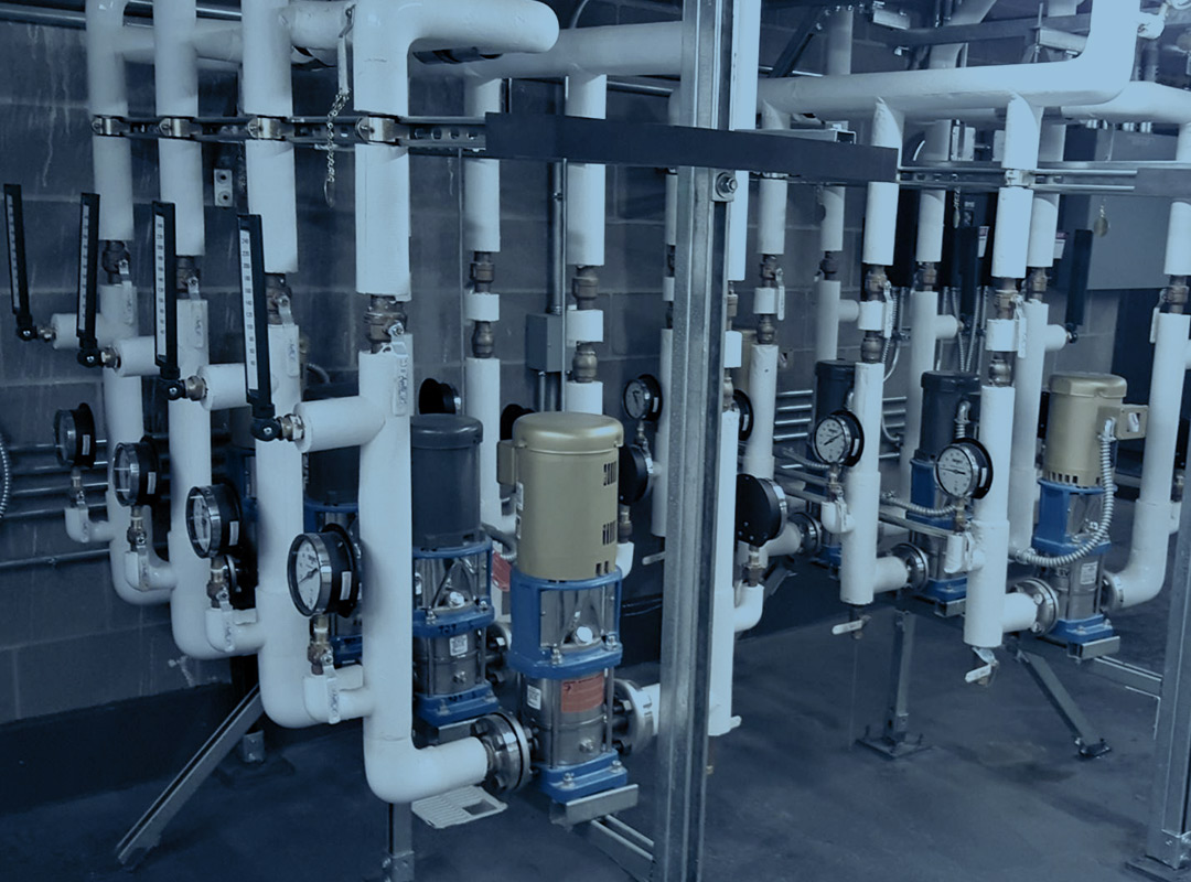 White pipes on a concrete surface show the plumbing installation job completed by UPM Mechanical in South Denver.