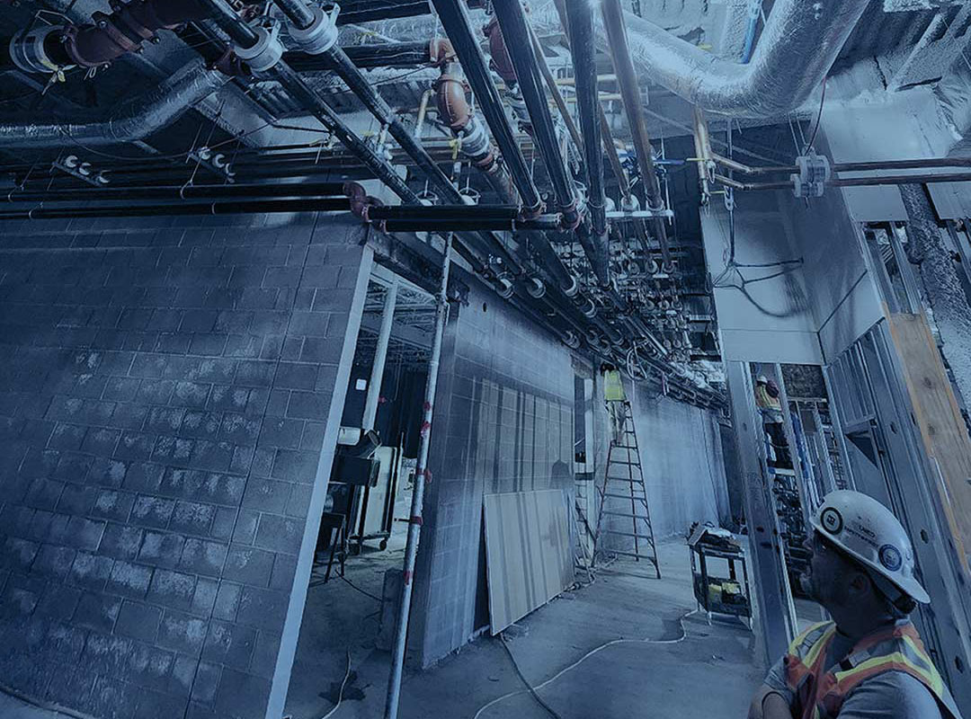 A service technician looks over a Mechanical Piping installation job of UPM Mechanical in Denver Colorado 